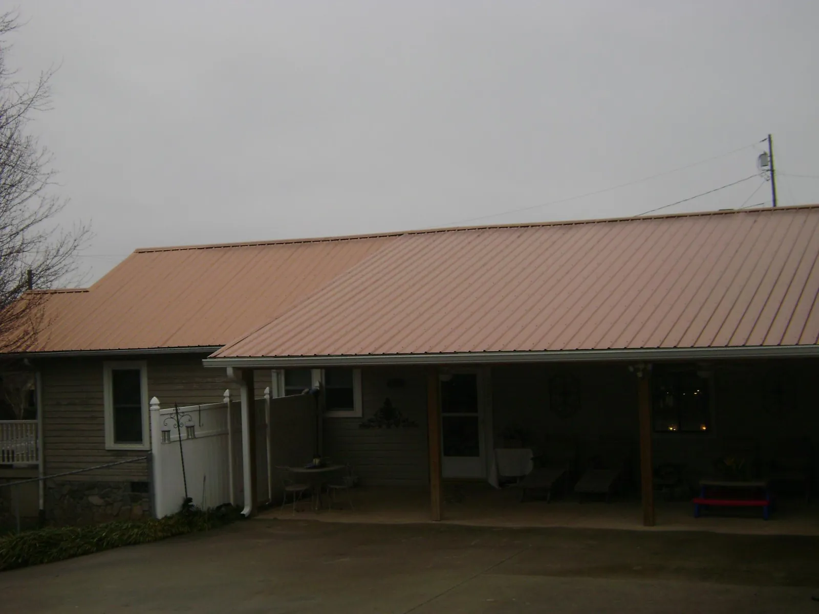 Copper toned metal roof over a wide covered patio in Quail Valley